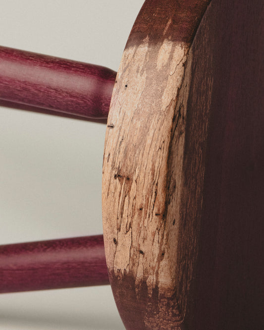 Detail of the seat in short purpleheart stool. Made by Yubero Torno.