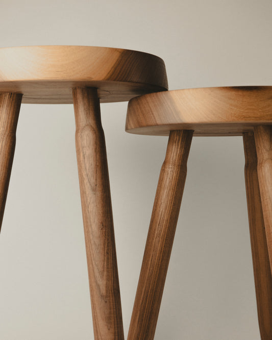 Detalle de la madera y patas torneadas de los taburetes Tria de nogal, hechos por Yubero Torno
