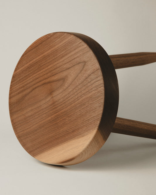 Detail of the seat in walnut short stool. Made by Yubero Torno.