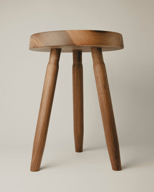 Short stool in walnut wood, front view. Made by Yubero Torno.
